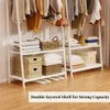 A white garment rack with clothes hanging on top and shelves below holding folded clothes, baskets, and boxes. Anteprima dell’immagine prodotto