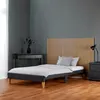 A bedroom scene with a bed, nightstand, and desk. Voir les images du produit