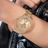 A close-up shot of a gold-colored Guess watch with crystal embellishments on a person's wrist. Podgląd zdjęcia produktu