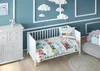 A nursery room with a crib, dresser, and chair, decorated with cloud-shaped hanging decorations. Produktbild-Vorschau