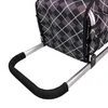 A close-up view of the handle and fabric of a shopping trolley. Produktbild-Vorschau