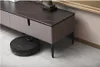 A robot vacuum cleaner is cleaning under a modern media console. Podgląd zdjęcia produktu