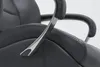 A close-up view of the armrest and seat of a black leather office chair. Voir les images du produit