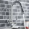 A chrome kitchen faucet with a pull-out spray head is shown against a gray brick tile backsplash. Náhľad obrázku produktu