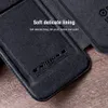 A close-up of a dark gray flip case with embossed branding and text. Podgląd zdjęcia produktu