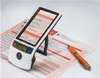 A digital magnifier is placed on top of a form, with a pen next to it. Anteprima dell’immagine prodotto