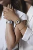 Two people's arms are crossed, each wearing a Casio watch. Produktbild-Vorschau