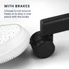 A white sneaker is shown pressing down on a black caster wheel with a brake mechanism. The image highlights the braking feature of the caster. Produktbild-Vorschau