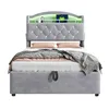 A gray upholstered bed with a tufted headboard and built-in shelving with LED lighting. Náhled obrázku produktu