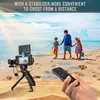 A family is enjoying a day at the beach, with a camera and tripod in the foreground. Produktbild-Vorschau