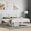 A white metal bed frame with a headboard is shown in a bedroom setting. Náhled obrázku produktu