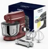 A red stand mixer with various attachments and its packaging, displayed on a white and light gray surface. Produktbild-Vorschau