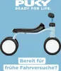 A Puky PUKYLINO retro blue balance bike is shown against a light blue background. Text overlays are present at the bottom. Náhled obrázku produktu