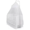 A white crib with a white mosquito net draped over it, supported by a stand. Produktbild-Vorschau