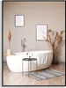 A modern bathroom with a freestanding bathtub, decorative plants, and artwork on the wall. Produktbild-Vorschau