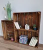 Two wooden crates are arranged as shelves, displaying various decorative items and books. Náhled obrázku produktu