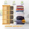 A laundry basket with a bamboo frame and multiple fabric drawers, next to a large stack of folded clothes. The image highlights the product's capacity and materials. Anteprima dell’immagine prodotto