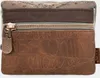 Close-up view of a brown leather pouch with embossed text and a zipper. Anteprima dell’immagine prodotto