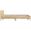 A side view of a wooden bed frame with a slatted base and a simple headboard, set against a plain white background. Voir les images du produit
