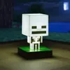 A Minecraft Skeleton lamp is displayed on a wooden surface with a blurred background of a Minecraft-like environment. Náhled obrázku produktu