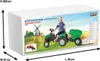 A child is riding a green pedal tractor with a green trailer on a box illustration depicting a farm scene. Produktbild-Vorschau