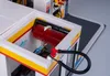 Close-up view of a Lego car wash with a red brush and blue water sprayers. Podgląd zdjęcia produktu