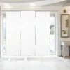 A modern interior with large white panel blinds covering a sliding glass door. Produktbild-Vorschau