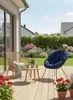 A patio scene with outdoor furniture and flowers. Produktbild-Vorschau
