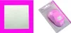 A collage of two images: a square of textured green material on a pink background on the left, and a pink paper punch in its packaging on the right. Produktbild-Vorschau