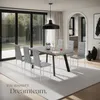 A dining room set with chairs and a table, with large windows and an archway leading to a kitchen. Náhled obrázku produktu