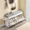 A shoe bench with storage in a hallway setting, with hats and a bag on the wall. Produktbild-Vorschau