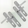 Four silver door handles are arranged diagonally on a light background. Náhľad obrázku produktu