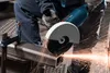 A person using a Bosch angle grinder to cut metal, with sparks flying. Produktbild-Vorschau