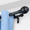 A close-up view of a double curtain rod with blue curtains. Voir les images du produit