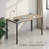 A desk with a laptop, lamp, and notebook. Produktbild-Vorschau