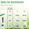 A table showing different sizes of a product with associated quantities, set against a background of grass and dew drops. Voir les images du produit