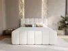 A modern bedroom with a white upholstered bed. Produktbild-Vorschau