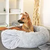 A dog lying in a plush dog bed in a home setting. Anteprima dell’immagine prodotto