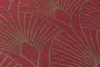 A close-up of a red and gold patterned wallpaper. Produktbild-Vorschau