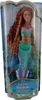 A doll in its packaging, featuring a mermaid design. Voir les images du produit
