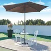 An outdoor patio set with a table, two chairs, and an umbrella. Náhled obrázku produktu