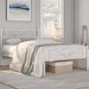 A white metal bed frame with a white comforter and blue throw blanket in a bedroom. Produktbild-Vorschau