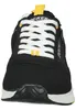 A close-up, front-facing view of a black Dockers sneaker with white laces and yellow accents. Voir les images du produit