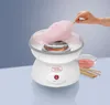 A cotton candy machine in use, with a hand making cotton candy. Podgląd zdjęcia produktu