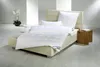 A neatly made bed with white bedding in a modern room. Produktbild-Vorschau