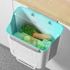 A hanging kitchen trash can filled with vegetables, attached to a cabinet door. Produktbild-Vorschau