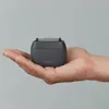 A hand holding a small electric shaver. Náhled obrázku produktu