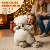 A young girl is hugging a large white teddy bear in a festive Christmas setting with a fireplace and Christmas tree. Anteprima dell’immagine prodotto