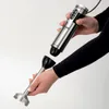 A person is holding an immersion blender and its detachable blending attachment, demonstrating how they connect. Anteprima dell’immagine prodotto