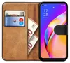 A book-style phone case with cards and banknotes inserted, displaying a smartphone screen. Anteprima dell’immagine prodotto